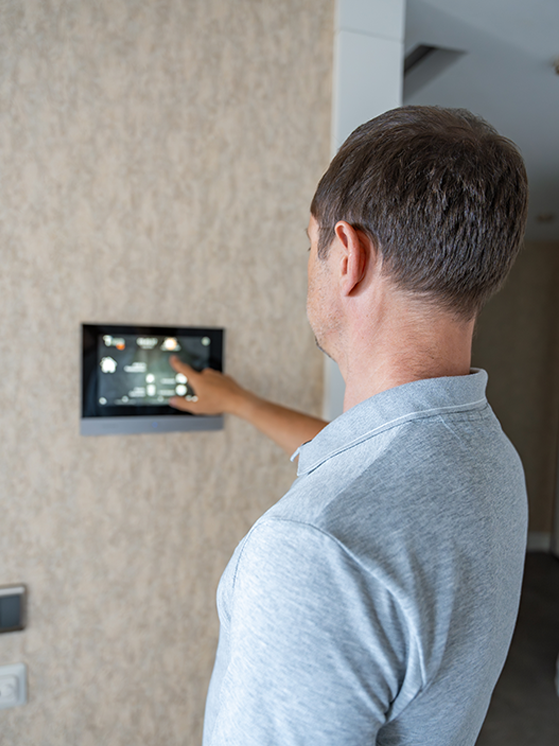 man-using-smart-thermostat-full-width