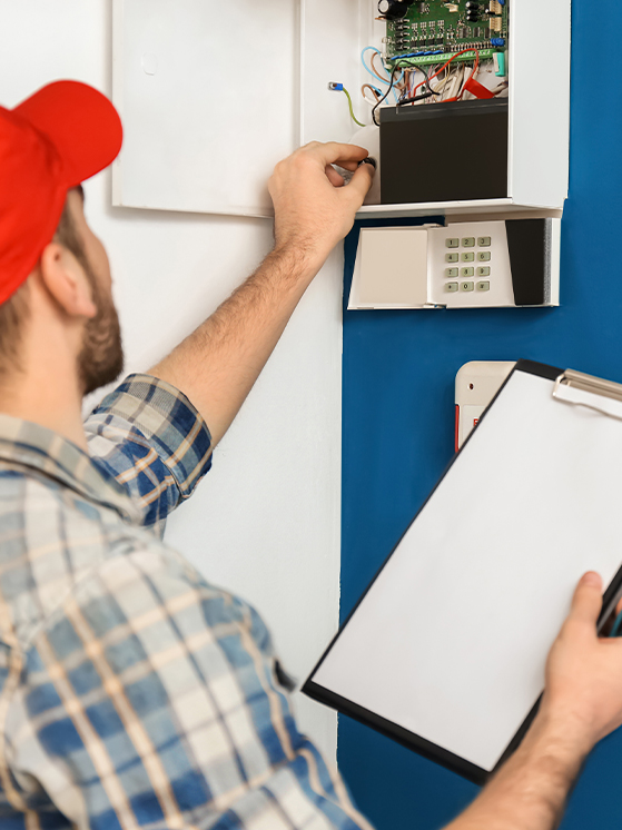 technician-installing-alarm-panel-in-home-full-width